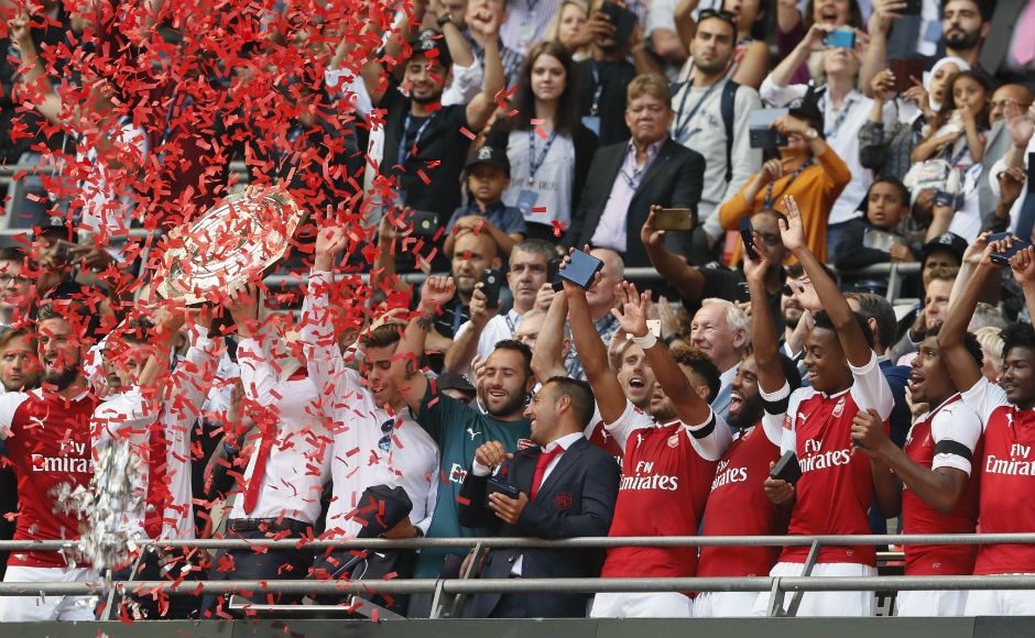 Arsenal players hold up the trophy after winning the English Community Shield. AP Arsenal players hold up the trophy after winning the English Community Shield. AP