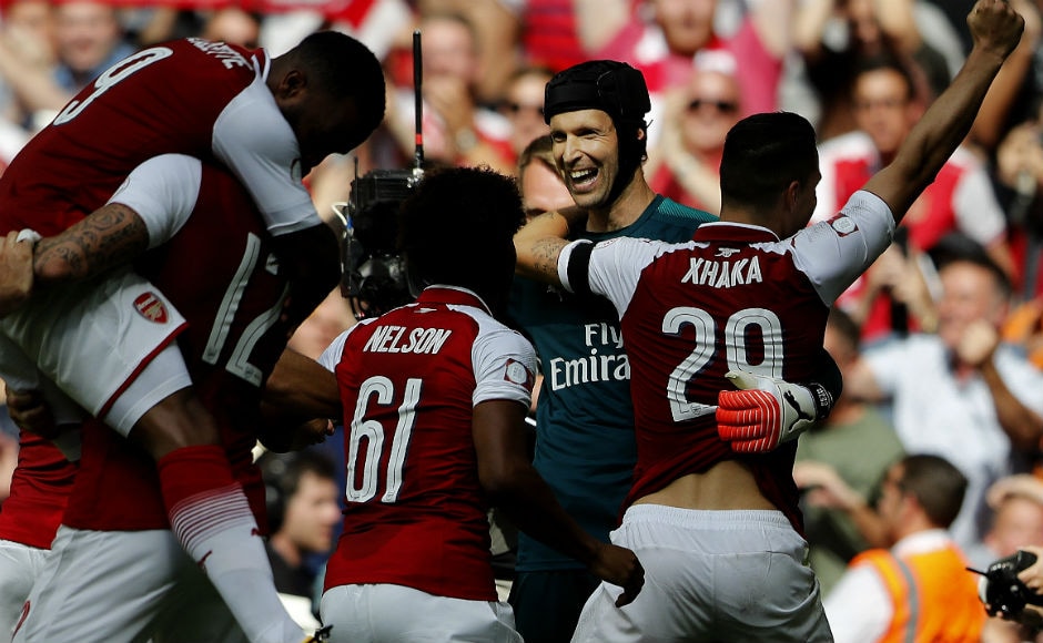 Arsenal's goalkeeper Petr Cech, center, celebrates with teammates after winning the Community Shield. AP Arsenal's goalkeeper Petr Cech, center, celebrates with teammates after winning the Community Shield. AP