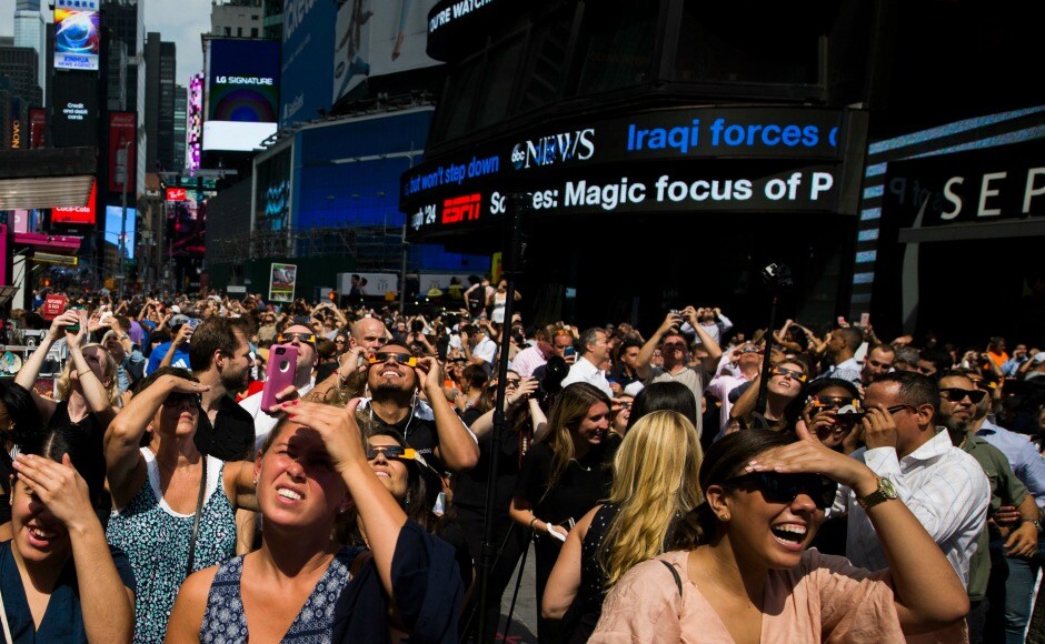 A huge crowd thronged Times Square in New York to see the crescent-shaped sun, although only 70 percent of the sun was seen covered by the moon in the city. AP A huge crowd thronged Times Square in New York to see the crescent-shaped sun, although only 70 percent of the sun was seen covered by the moon in the city. AP