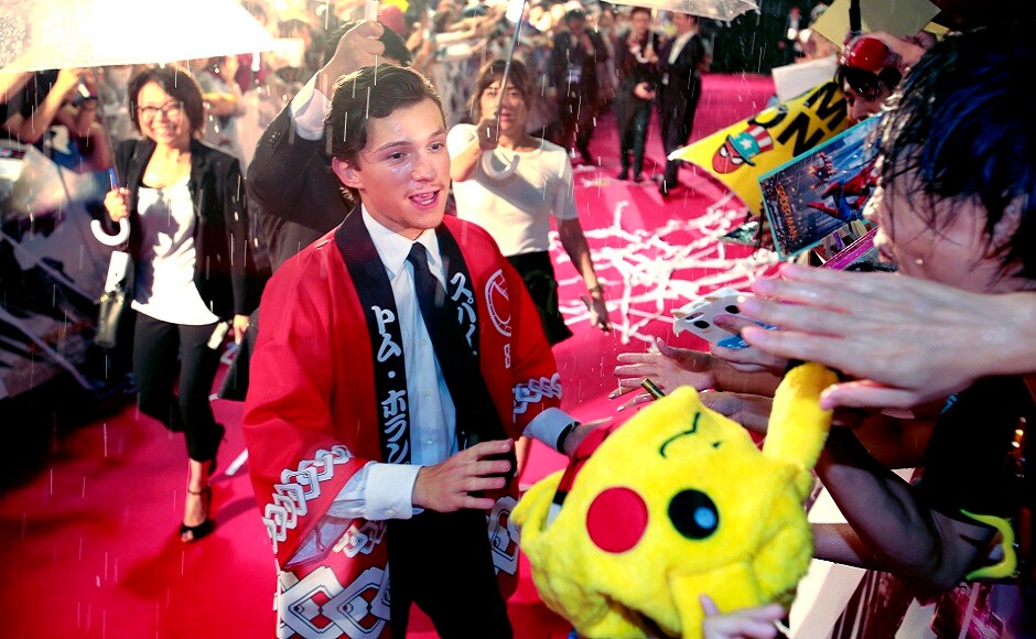 Holland smiles at fans upon his arrival for the Japan premiere for his latest film 'Spider-Man: Homecoming' in Tokyo, Monday, 7 August, 2017. Image via AP/Shizuo Kambayashi. Holland smiles at fans upon his arrival for the Japan premiere for his latest film 'Spider-Man: Homecoming' in Tokyo, Monday, 7 August, 2017. Image via AP/Shizuo Kambayashi.