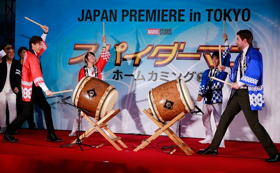 Holland (left) and director Jon Watts (right), beat traditional drums during the Japan premiere for their latest film 'Spider-Man: Homecoming' in Tokyo, Monday, 7 August, 2017. Image via AP/Shizuo Kambayashi. Holland (left) and director Jon Watts (right), beat traditional drums during the Japan premiere for their latest film 'Spider-Man: Homecoming' in Tokyo, Monday, 7 August, 2017. Image via AP/Shizuo Kambayashi.