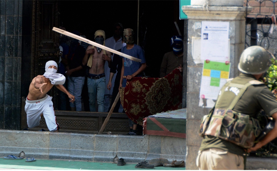 A youth throws a wooden rod towards a policeman during clashes after the protests in Srinagar on Friday. Omar Abdullah, former chief minister, said what Mufti said did not matter and asked the Prime Minister's Office for clarifying the "assurances". PTI A youth throws a wooden rod towards a policeman during clashes after the protests in Srinagar on Friday. Omar Abdullah, former chief minister, said what Mufti said did not matter and asked the Prime Minister's Office for clarifying the "assurances". PTI