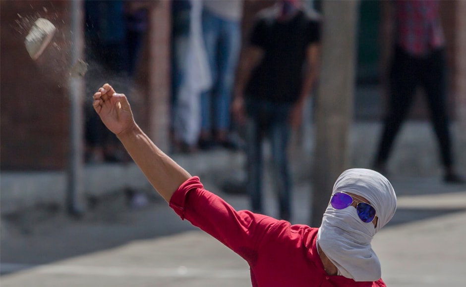 A Kashmiri protester throws a rock at government forces in Srinagar. The BJP state unit on Thursday, however, had said that it was time to revoke Article 35A for it created a "separatist emotion" in the state. AP A Kashmiri protester throws a rock at government forces in Srinagar. The BJP state unit on Thursday, however, had said that it was time to revoke Article 35A for it created a "separatist emotion" in the state. AP