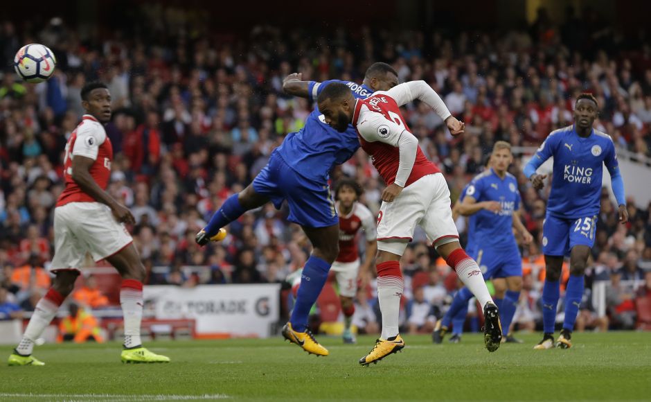 Arsenal's Alexandre Lacazette, centre heads the ball to score the opening goal of the game during their Premier League. Record-signing Lacazette launched his English league career in style by heading in the opener after 94 seconds. AP Arsenal's Alexandre Lacazette, centre heads the ball to score the opening goal of the game during their Premier League. Record-signing Lacazette launched his English league career in style by heading in the opener after 94 seconds. AP