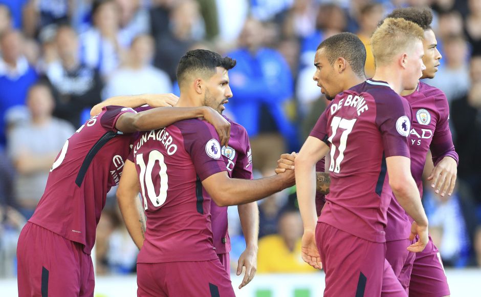 Manchester City's Sergio Aguero, centre, celebrates scoring his side's first goal teammates. Brighton defender Lewis Dunk slammed a header into his own net as he tried to clear a cross under pressure from Gabriel Jesus, with the home side lacking the firepower to mount a comeback in the closing stages. AP Manchester City's Sergio Aguero, centre, celebrates scoring his side's first goal teammates. Brighton defender Lewis Dunk slammed a header into his own net as he tried to clear a cross under pressure from Gabriel Jesus, with the home side lacking the firepower to mount a comeback in the closing stages. AP