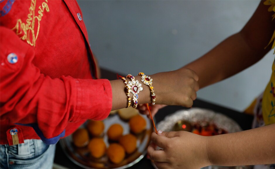 A girl ties rakhis on her brother's wrist in Allahabad. During the festival, sisters tie a sacred thread (rakhi) around their brothers wrists, and with the brothers vowing to protect their sisters. AP A girl ties rakhis on her brother's wrist in Allahabad. During the festival, sisters tie a sacred thread (rakhi) around their brothers wrists, and with the brothers vowing to protect their sisters. AP