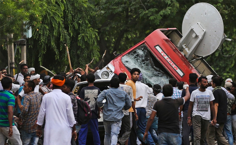 Enraged by the rape conviction of self-styled godman Gurmeet Ram Rahim Singh on Friday, his followers went on the rampage, hurling stones and vandalising media vehicles. At least three outdoor broadcast vans of private television channels were damaged. One van was overturned by a mob. AP Enraged by the rape conviction of self-styled godman Gurmeet Ram Rahim Singh on Friday, his followers went on the rampage, hurling stones and vandalising media vehicles. At least three outdoor broadcast vans of private television channels were damaged. One van was overturned by a mob. AP