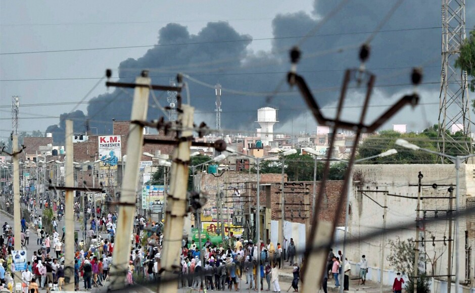 Smoke arises in the distance in Sirsa, Haryana, where the Dera Sacha Sauda's headquarters are located. The situation continued to deteriorate throughout Saturday, with the police unable to control the mob. Forces had to reportedly to escape three times themselves, to run from Dera supporters. PTI Smoke arises in the distance in Sirsa, Haryana, where the Dera Sacha Sauda's headquarters are located. The situation continued to deteriorate throughout Saturday, with the police unable to control the mob. Forces had to reportedly to escape three times themselves, to run from Dera supporters. PTI