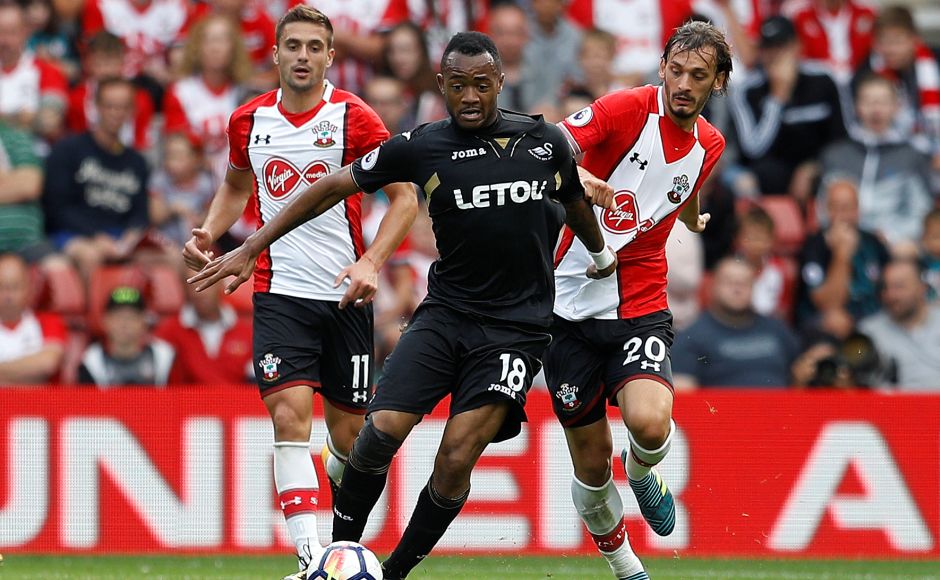 Swansea City's Jordan Ayew in action with Southampton's Dusan Tadic and Manolo Gabbiadini. Southampton were held by Swansea City to a goalless draw in Mauricio Pellegrino's first competitive match in charge of the Saints. Swansea City's Jordan Ayew in action with Southampton's Dusan Tadic and Manolo Gabbiadini. Southampton were held by Swansea City to a goalless draw in Mauricio Pellegrino's first competitive match in charge of the Saints.