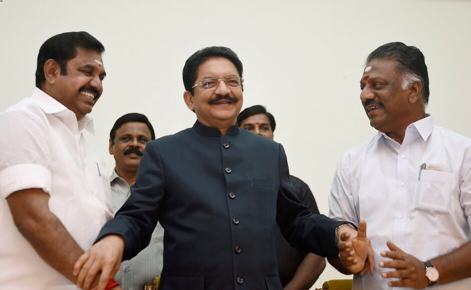 Tamil Nadu chief minister K Palaniswamy (L) greets O Panneerselvam (R) after he was sworn-in as the deputy chief minister in the presence of governor CH Vidyasagar Rao (C) at Raj Bhavan in Chennai on Monday. All India Anna Dravida Munnetra Kazhagam factions led by Palaniswamy and Panneerselvam formally merged on Monday afternoon. PTI Tamil Nadu chief minister K Palaniswamy (L) greets O Panneerselvam (R) after he was sworn-in as the deputy chief minister in the presence of governor CH Vidyasagar Rao (C) at Raj Bhavan in Chennai on Monday. All India Anna Dravida Munnetra Kazhagam factions led by Palaniswamy and Panneerselvam formally merged on Monday afternoon. PTI