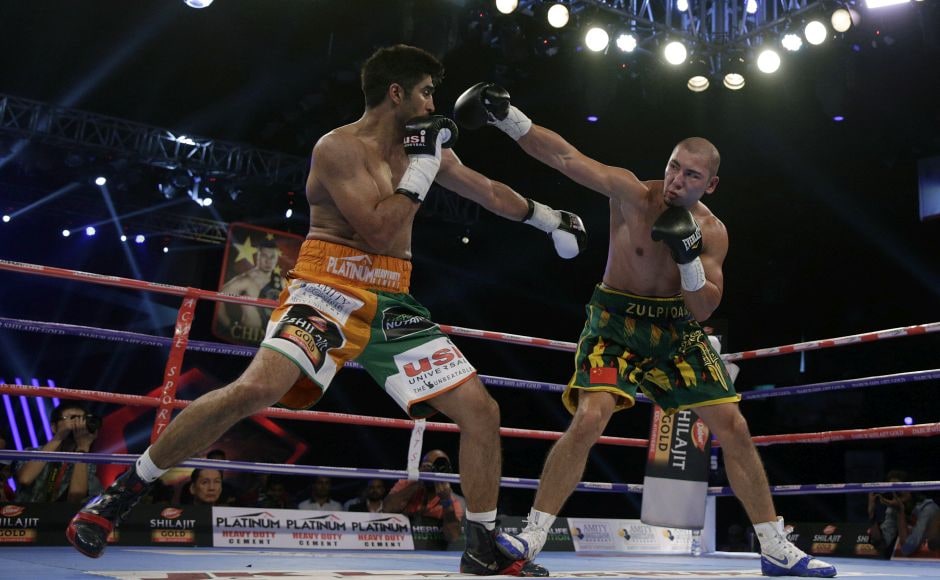 Vijender Singh (L) throws a punch at Zulpikar Maimaitiali (R) during their double title bout. AP Vijender Singh (L) throws a punch at Zulpikar Maimaitiali (R) during their double title bout. AP