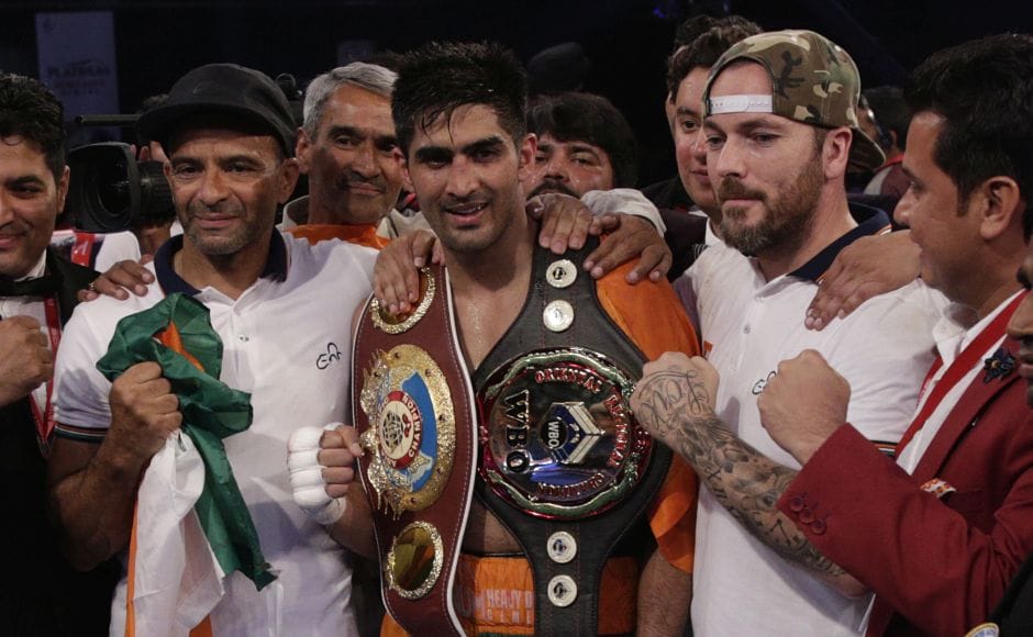 Vijender Singh, centre, celebrates after winning the double title against WBO Oriental Super Middleweight champion of China Zulpikar Maimaitiali. AP Vijender Singh, centre, celebrates after winning the double title against WBO Oriental Super Middleweight champion of China Zulpikar Maimaitiali. AP