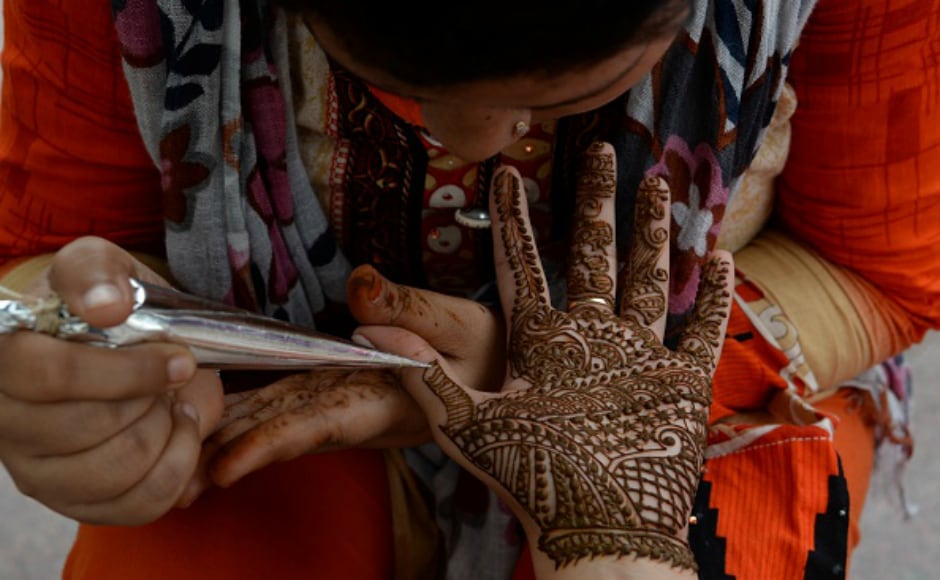 An Indian customer gets her hand is decorated with henna on the eve of the Rakhi festival in New Delhi. During the festival, sisters tie a sacred thread (rakhi) around their brothers wrists, and in return the brothers vow to protect their sisters. Getty images An Indian customer gets her hand is decorated with henna on the eve of the Rakhi festival in New Delhi. During the festival, sisters tie a sacred thread (rakhi) around their brothers wrists, and in return the brothers vow to protect their sisters. Getty images