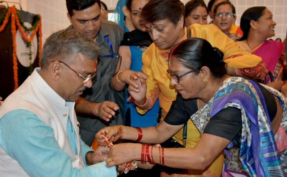 Women tie rakhi to Uttarakhand chief minister Trivendra Singh Rawat on the eve of Raksha Bandhan, in Dehradun. PTI Women tie rakhi to Uttarakhand chief minister Trivendra Singh Rawat on the eve of Raksha Bandhan, in Dehradun. PTI