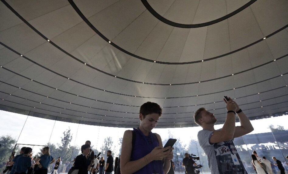 Press and media waiting inside the Steve Jobs Theater are busy taking pictures of the space inside. Image: AP Photo. Press and media waiting inside the Steve Jobs Theater are busy taking pictures of the space inside. Image: AP Photo.