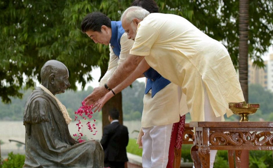 Dressed in a crimson Kurta, Abe, his wife and Modi then paid thier tributes to Mahatma Gandhi at the famed Sabarmati Ashram. PTI Dressed in a crimson Kurta, Abe, his wife and Modi then paid thier tributes to Mahatma Gandhi at the famed Sabarmati Ashram. PTI