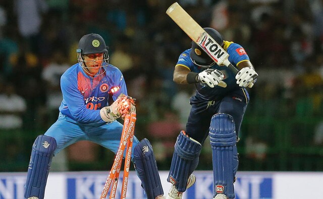 India's Mahendra Singh Dhoni successfully breaks the wicket to dismiss Angelo Mathews . AP India's Mahendra Singh Dhoni successfully breaks the wicket to dismiss Angelo Mathews . AP