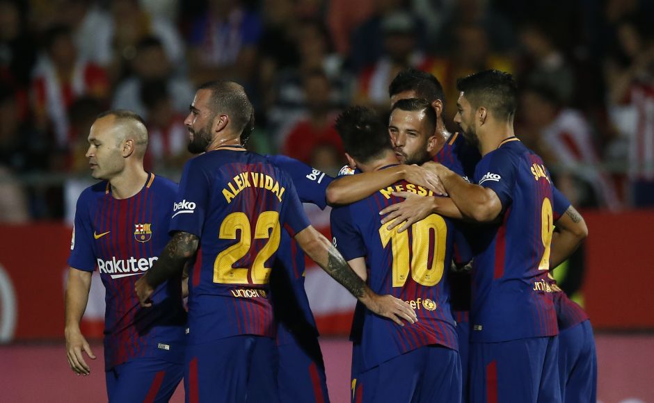 FC Barcelona's players celebrate a goal. Girona succeeded in stopping Barcelona star Lionel Messi from scoring. If only it could have avoided its own net as well. AP Barcelona's Luiz Suarez scores in 100th La Liga appearance, Real Madrid win on Cristiano Ronaldo's return