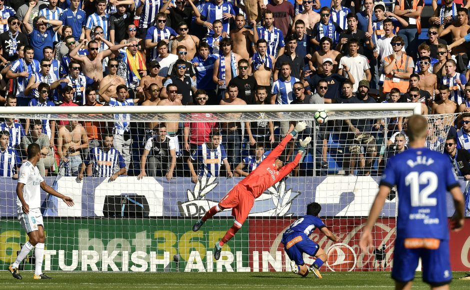 Alaves' Manu Garcia (bottom R) scores in front Real Madrid's goalkeeper Keylor Navas during the La Liga match. Garcia responded with Alaves' first goal of the season. AP Barcelona's Luiz Suarez scores in 100th La Liga appearance, Real Madrid win on Cristiano Ronaldo's return