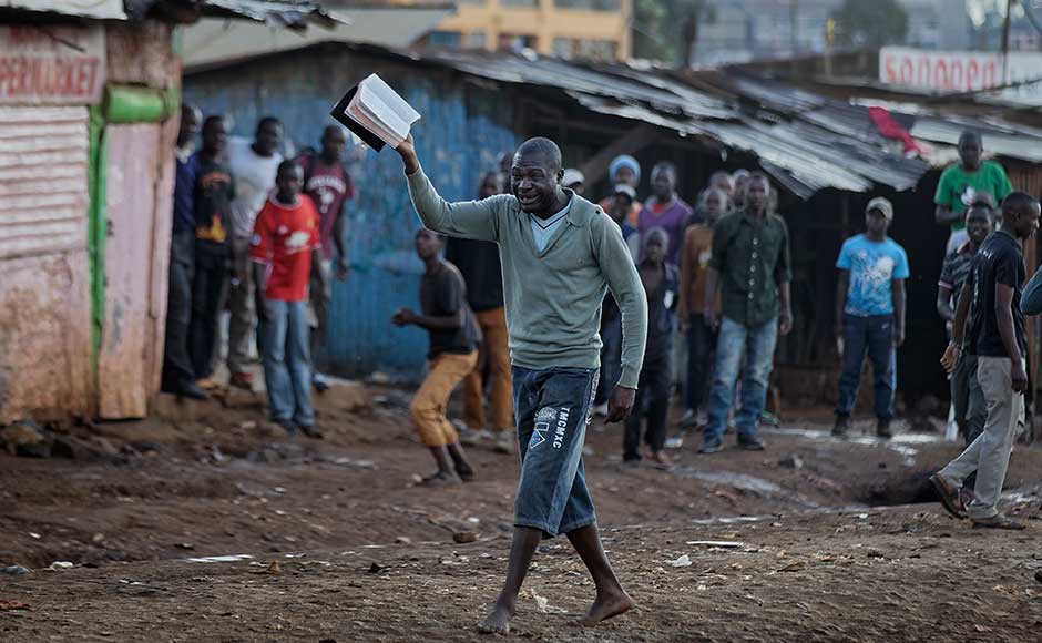 It was the second voting delay in four out of Kenya's 47 counties, highlighting the bitter divisions and political uncertainty that have intensified after Thursday's repeat presidential election. An opposition supporter holds a bible towards a police water cannon truck, while others carry rocks to throw at the truck, in the Kawangware slum of Nairobi. AP
