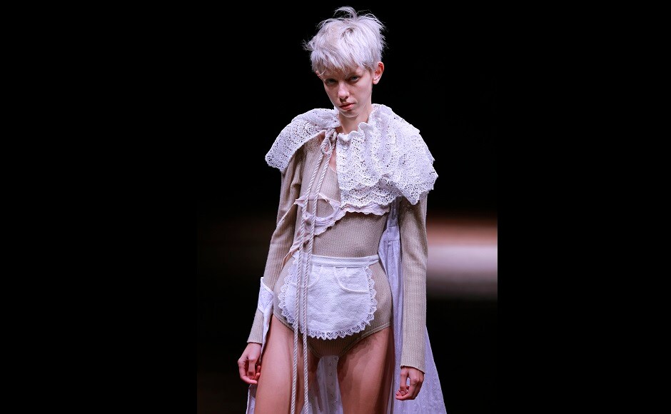 This model sports an apron and a cape made of lace. (AP Photo/Shizuo Kambayashi) This model sports an apron and a cape made of lace. (AP Photo/Shizuo Kambayashi)