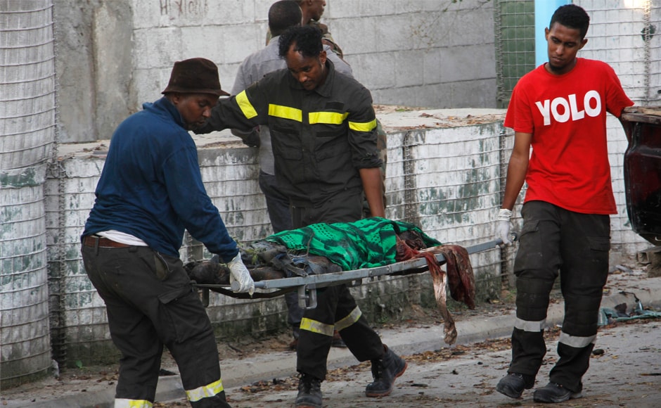 A dead body is carried in Mogadishu. Security officials say the bomber had pretended that his truck had broken down outside the hotel gate. The bomber stopped outside the heavily fortified hotel and pretended to repair the truck before finally turning it around and detonating. AP A dead body is carried in Mogadishu. Security officials say the bomber had pretended that his truck had broken down outside the hotel gate. The bomber stopped outside the heavily fortified hotel and pretended to repair the truck before finally turning it around and detonating. AP
