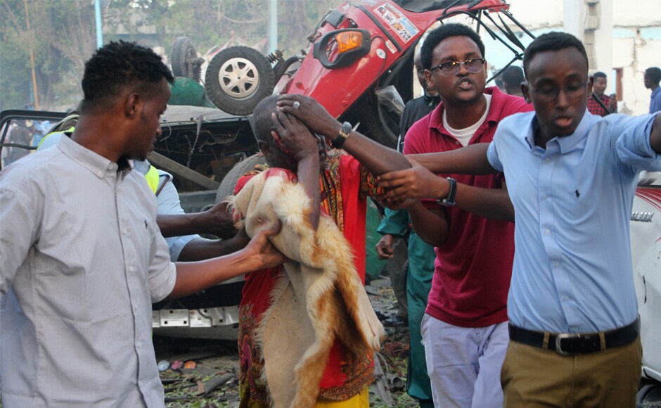 Somalis help a man injured in the blast. Saturday's blasts came two weeks after more than 350 people were killed in a massive truck bombing on a busy Mogadishu street, in the country's worst-ever attack. AP Somalis help a man injured in the blast. Saturday's blasts came two weeks after more than 350 people were killed in a massive truck bombing on a busy Mogadishu street, in the country's worst-ever attack. AP