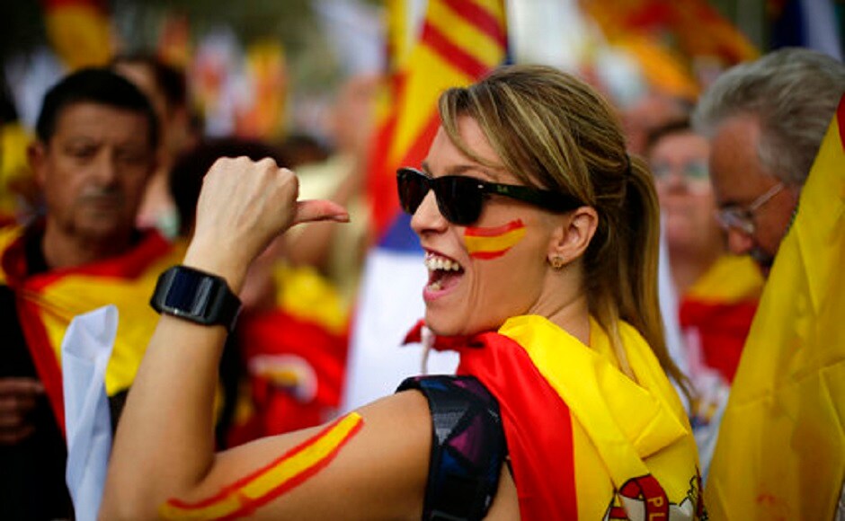 Spanish flags were tied to balconies and windows around the city by pro-unity supporters on the nationwide holiday. AP Spain celebrates national day amid Catalan independence referendum crisis