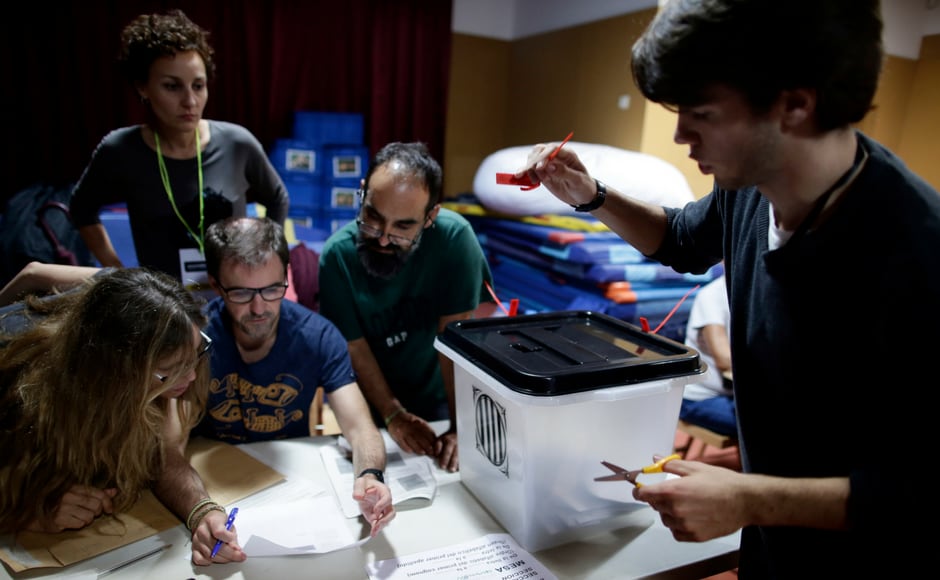A ballot box is opened as officials get ready to count votes at the La Llacuna del Poblenou school assigned to be a polling station by the Catalan government in Barcelona, Spain on Sunday evening. During the day, Spanish riot police smashed their way into polling stations to try to halt a disputed independence referendum and fired rubber bullets at protesters. AP A ballot box is opened as officials get ready to count votes at the La Llacuna del Poblenou school assigned to be a polling station by the Catalan government in Barcelona, Spain on Sunday evening. During the day, Spanish riot police smashed their way into polling stations to try to halt a disputed independence referendum and fired rubber bullets at protesters. AP