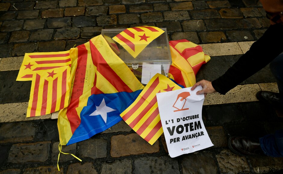 A pro independence supporter holds up a sign calling for the vote close to a mock ballot boxes covered with ''esteleda'' or Catalan pro independence flags in support of the Catalonia's secession referendum, in Pamplona, northern Spain on Sunday. AP A pro independence supporter holds up a sign calling for the vote close to a mock ballot boxes covered with ''esteleda'' or Catalan pro independence flags in support of the Catalonia's secession referendum, in Pamplona, northern Spain on Sunday. AP