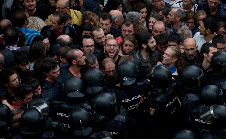 Spanish National Police block people trying to reach a voting site at a school assigned to be a polling station by the Catalan government in Barcelona, Spain. Catalan leaders accused Spanish police of brutality and repression while the Spanish government praised the security forces for behaving firmly and proportionately. AP Spanish National Police block people trying to reach a voting site at a school assigned to be a polling station by the Catalan government in Barcelona, Spain. Catalan leaders accused Spanish police of brutality and repression while the Spanish government praised the security forces for behaving firmly and proportionately. AP