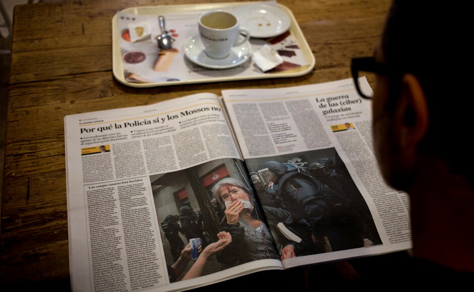 A man reads a newspaper featuring the news following a disputed referendum marred by violence in Barcelona, Spain on Monday. AP A man reads a newspaper featuring the news following a disputed referendum marred by violence in Barcelona, Spain on Monday. AP