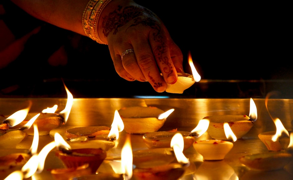 A Hindu devotee light up clay oil lamps while praying at a temple during Deepavali celebration in Kuala Lumpur, Malaysia. AP India's streets deck up with lanterns, diyas as people gear up to celebrate Diwali
