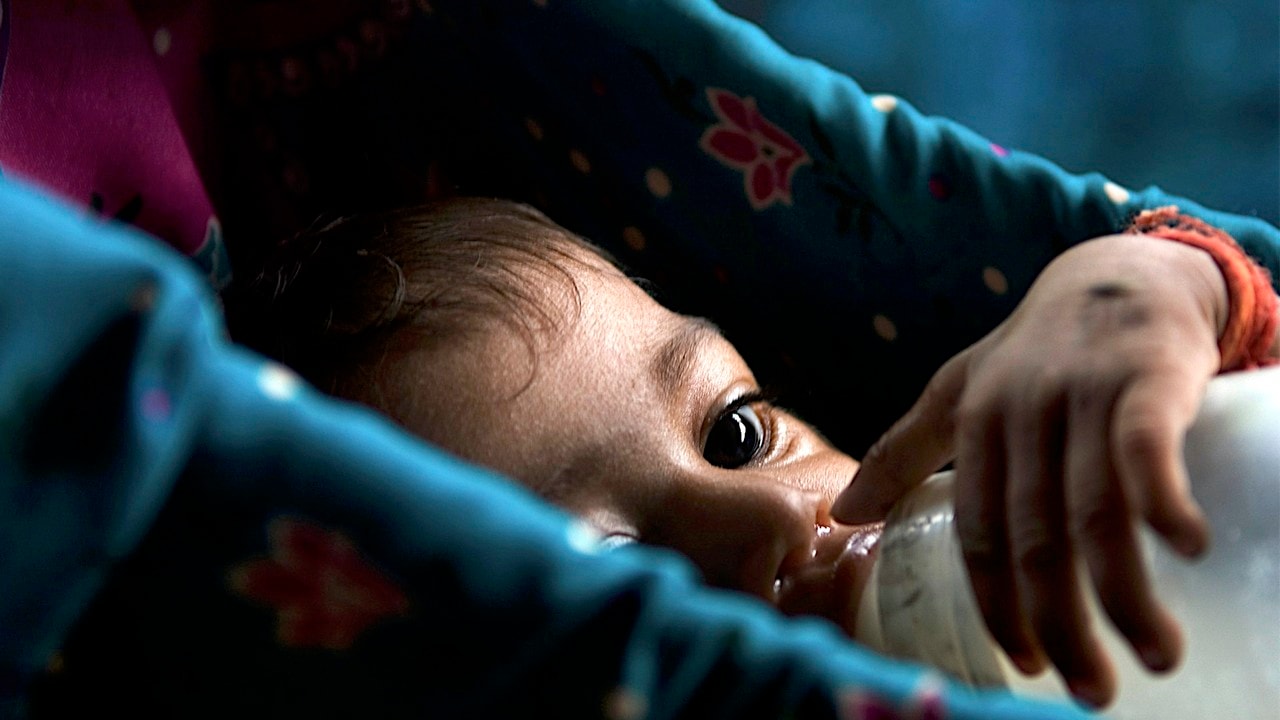 Seven-month-old Rohini who is suffering from malnutrition drinks milk inside a hut in Mumbai July 25, 2007. The seven-month-old twins Rohini and her brother Rohit from a tribal family have been declared malnourished by a team of the city's civic administration doctors, local media reported. India, home to millions of underfed children despite its flourishing economy, will have eradicated malnutrition by 2015, the country's health minister said. A government survey released this year however found that 46 percent of children under the age of three years were undernourished. Reuters