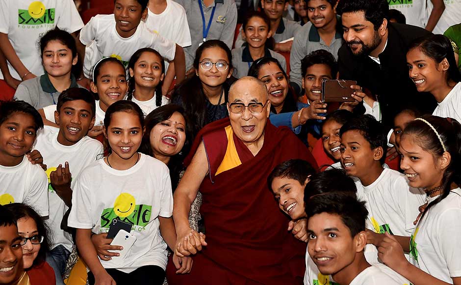 Tibetan spiritual leader Dalai Lama attended the Smile Foundation's initiative, 'The World of Children' in New Delhi on Sunday. Dalai Lama poses for a group photo with school students during the event. PTI Dalai Lama discusses education, universal responsibility at 'The World of Children' event in Delhi