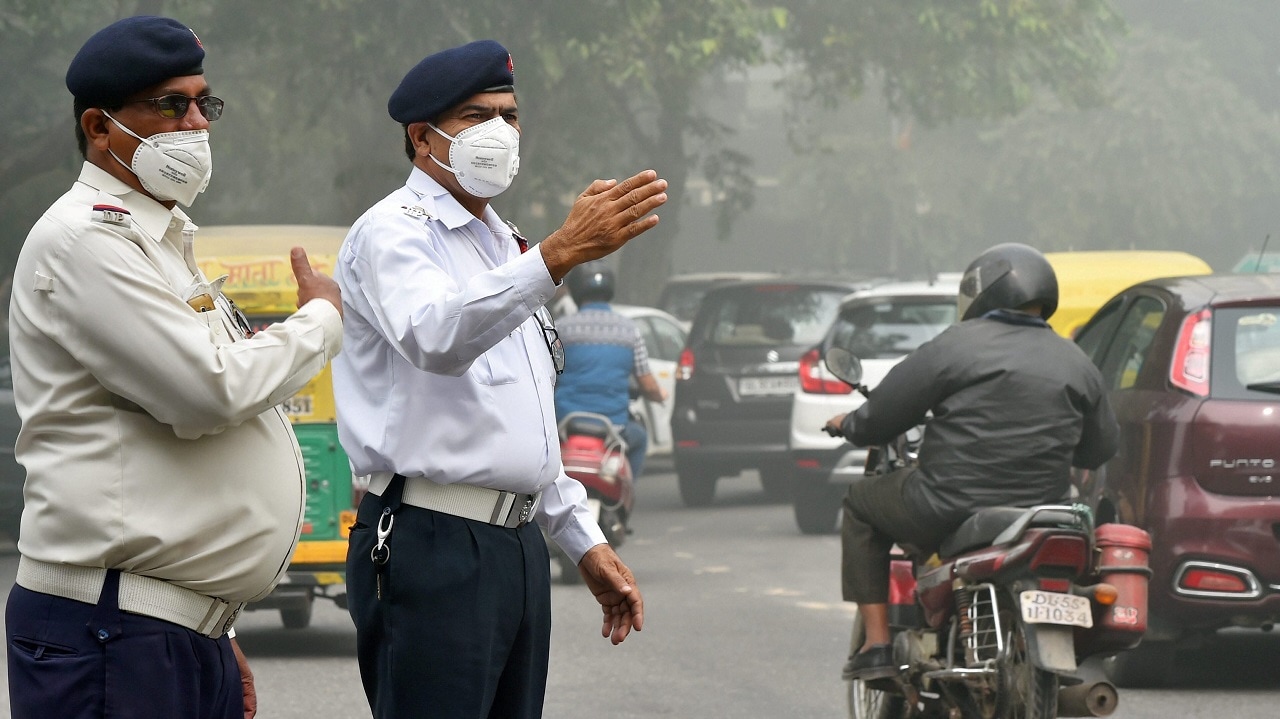 Traffic policemen wear masks to protect themselves from heavy smog and air pollution in New Delhi. PTI