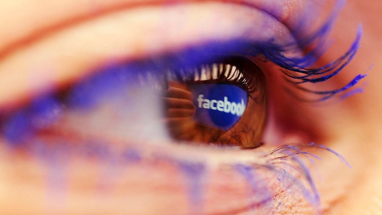 A Facebook logo reflected in the eye of a woman is seen in this picture illustration taken in Skopje November 6, 2014. Picture take November6. REUTERS/Ognen Teofilovski (MACEDONIA - Tags: BUSINESS LOGO) - LR1EABA15LWI6