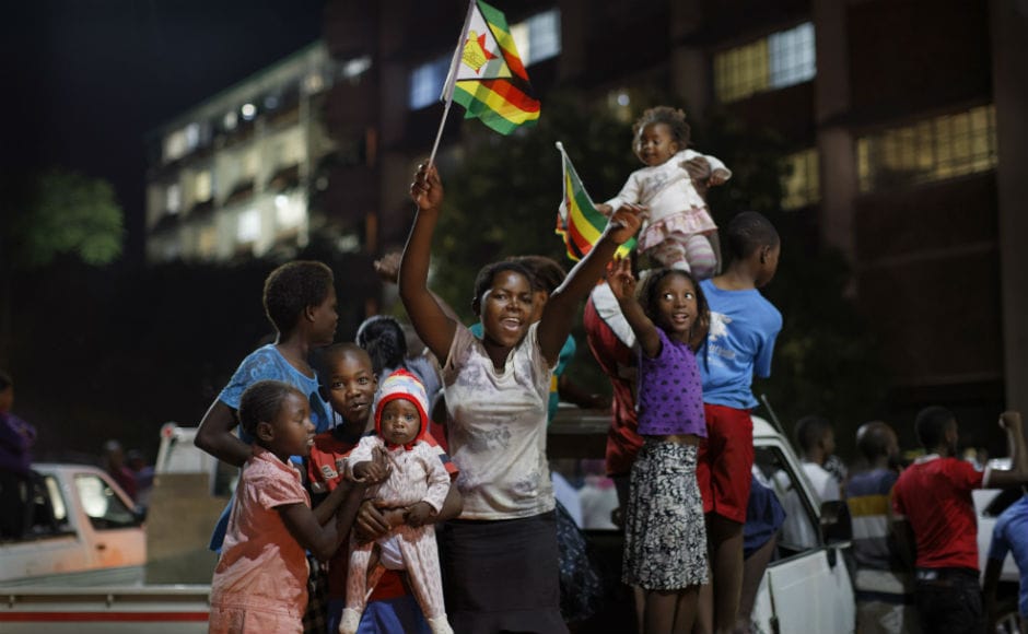 The crowds gathered brandishing national flags and often praising army chief General Constantino Chiwenga who led the military's power-grab. Some people were holding posters of Zimbabwean army chief Constantino Chiwenga and Mnangagwa, whose sacking this month triggered the military takeover. Robert Mugabe resigns as Zimbabwe's president, ushers tears and joy of celebrations on the streets