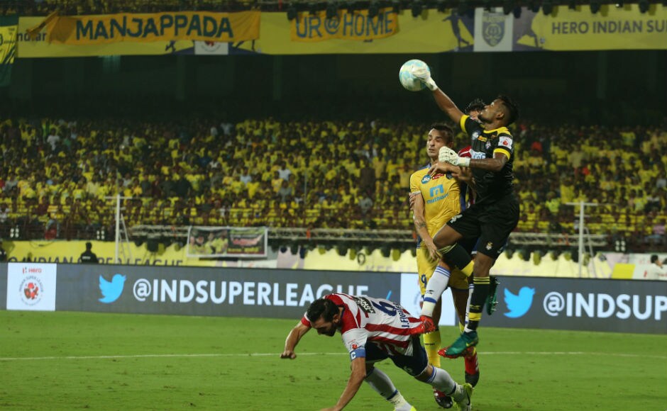 Debjit Majumder of ATK punches the ball while Dimitar Berbatov tries to head it down. ISL Debjit Majumder of ATK punches the ball while Dimitar Berbatov tries to head it down. ISL