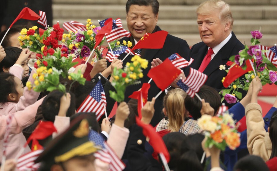 Children waved US and Chinese flags at Donald Trump and Xi Jinping, who were due to hold private talks. AP Donald Trump receives elaborate welcome on first visit to China, holds talks with Xi Jinping