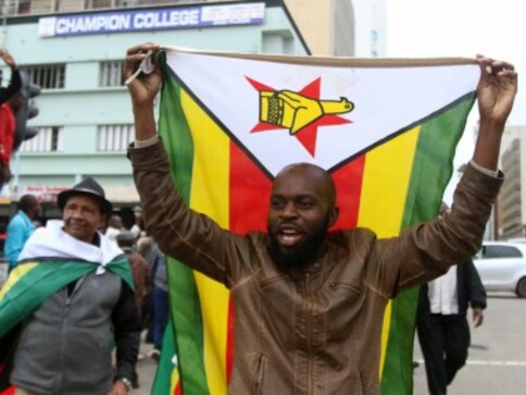 Ecstatic Zimbabweans flood streets of Harare celebrating President Robert Mugabe's expected downfall Ecstatic Zimbabweans flood streets of Harare celebrating President Robert Mugabe's expected downfall