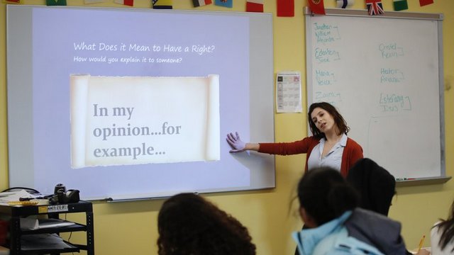 Teacher Phoebe Sherman talks to students before working with the civics computer game iCivics during her 11th grade social studies class at Roosevelt High School's International Academy in Washington. Image: AP