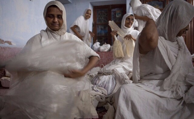 Briana’s series of photographs represents the artist’s dilemmas and spiritual inquires as they manifested during her journey across borders. Here, Swetamber Jain nuns unfolding layers of cloth. Jharkhand. Briana Blasko/Vadehra Art Gallery Briana’s series of photographs represents the artist’s dilemmas and spiritual inquires as they manifested during her journey across borders. Here, Swetamber Jain nuns unfolding layers of cloth. Jharkhand. Briana Blasko/Vadehra Art Gallery