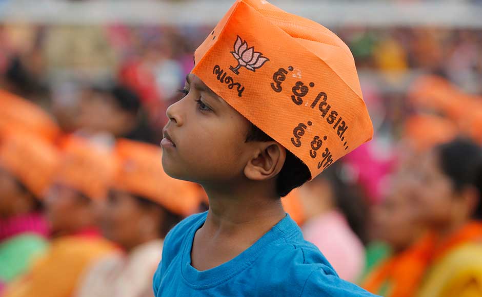 Modi held 'vikas rallies' in Bharuch, Surendranagar and Rajkot. He also inaugurated Shri Jogiswami SGVP Hospital in Ahmedabad. A child listen's to Modi's speech at an election rally. His cap has the party slogan for the 2017 Gujarat polls — 'I am development, I am Gujarat.' AP Modi held 'vikas rallies' in Bharuch, Surendranagar and Rajkot. He also inaugurated Shri Jogiswami SGVP Hospital in Ahmedabad. A child listen's to Modi's speech at an election rally. His cap has the party slogan for the 2017 Gujarat polls — 'I am development, I am Gujarat.' AP