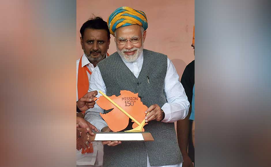 Later, while addressing a rally in Kaalol town, Modi accused the Congress of sowing seeds of enmity between various communities for power. Modi being presented a Gujarat map memento by the BJP workers. PTI Later, while addressing a rally in Kaalol town, Modi accused the Congress of sowing seeds of enmity between various communities for power. Modi being presented a Gujarat map memento by the BJP workers. PTI