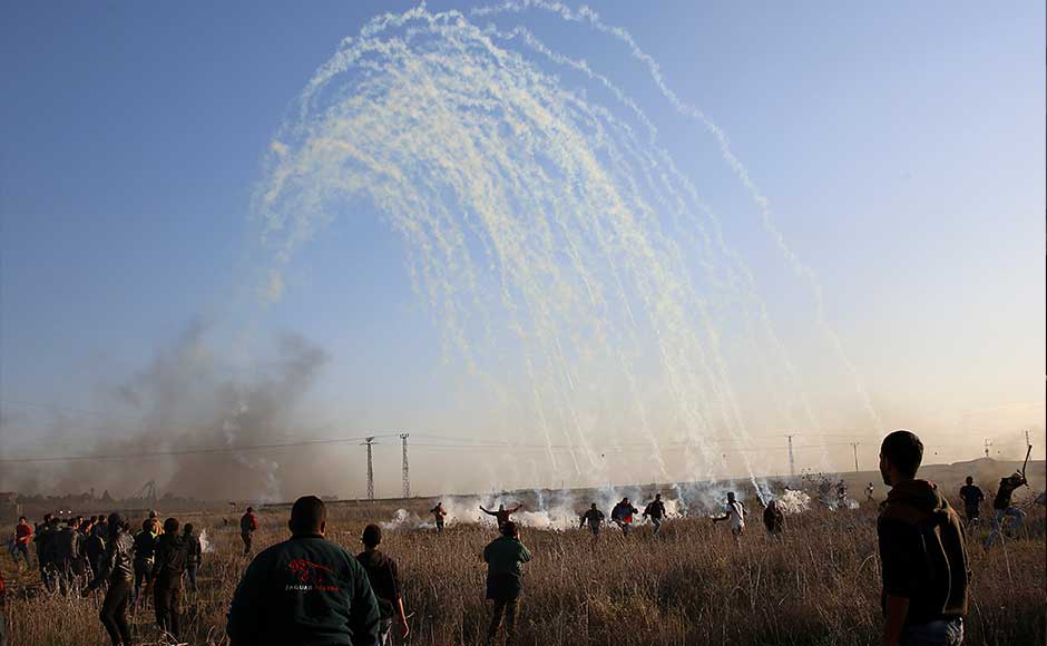 In the West Bank, troops fired water cannons and tear gas to disperse a crowd in Bethlehem, the biblical town of Jesus' birth, just weeks before thousands of foreign tourists are expected to visit for Christmas celebrations. Palestinian protesters run for cover from teargas fired by Israeli soldiers during clashes on the Israeli border. AP In the West Bank, troops fired water cannons and tear gas to disperse a crowd in Bethlehem, the biblical town of Jesus' birth, just weeks before thousands of foreign tourists are expected to visit for Christmas celebrations. Palestinian protesters run for cover from teargas fired by Israeli soldiers during clashes on the Israeli border. AP