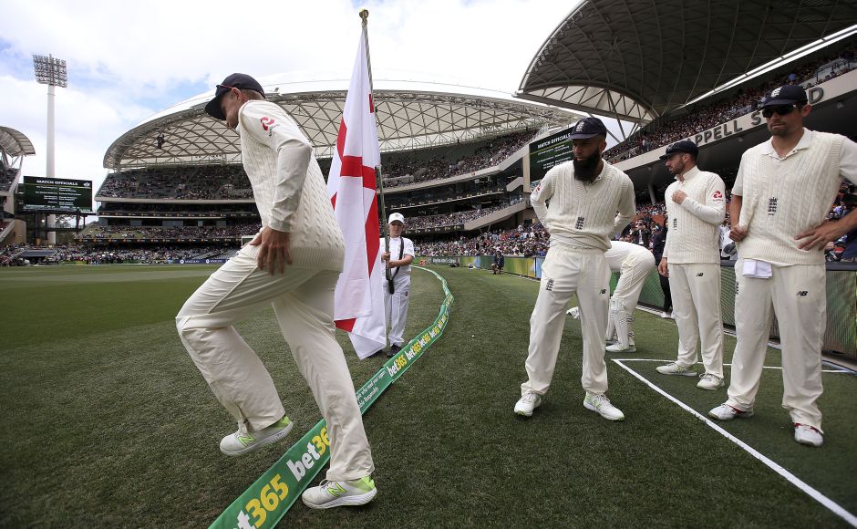 England's captain Joe Root, left, leads his team onto the ground for the second day of their Ashes Test match against Australia on sunday. AP Shaun Marsh's century puts Australia in charge after Day 2 of Ashes 2nd Test