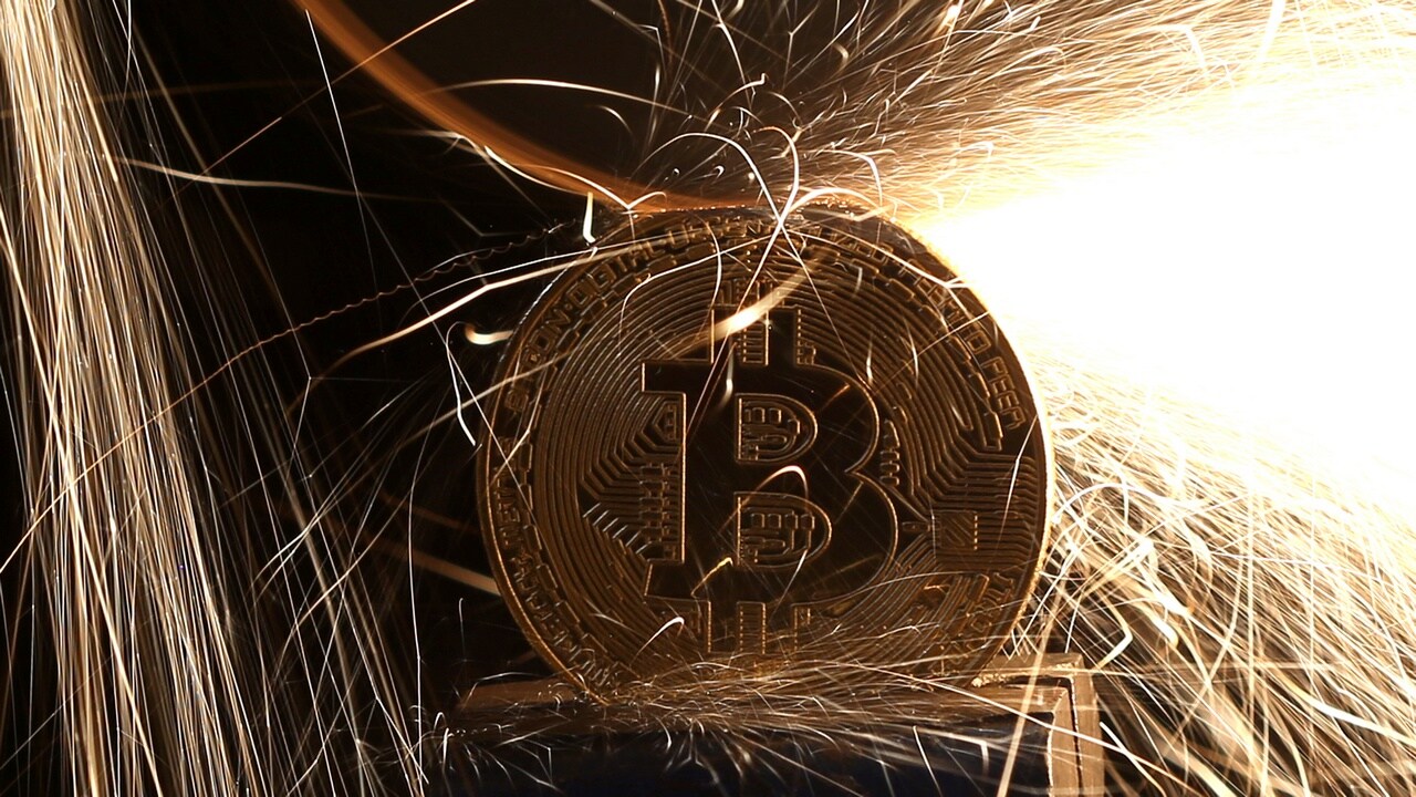 Sparks glow from broken Bitcoin (virtual currency) coins. Image: Reuters