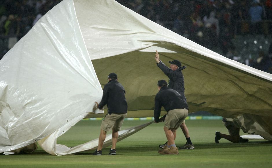 Grounds crew struggle to control the cover for the pitch as rain begins to fall during the second day at Adelaide. England had made 29 for one in reply when rain brought a premature end to the day’s playAP Shaun Marsh's century puts Australia in charge after Day 2 of Ashes 2nd Test