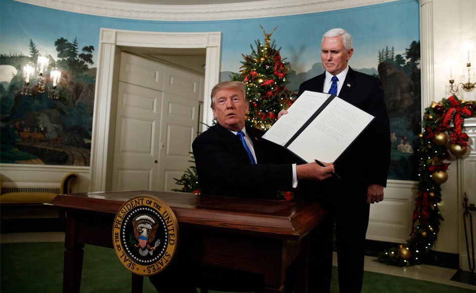 Donald Trump, accompanied by Vice-President Mike Pence, holds up a signed proclamation recognising Jerusalem as the capital of Israel. He also said the United States would move its embassy from Tel Aviv to Jerusalem, though he set no timetable. AP Donald Trump, accompanied by Vice-President Mike Pence, holds up a signed proclamation recognising Jerusalem as the capital of Israel. He also said the United States would move its embassy from Tel Aviv to Jerusalem, though he set no timetable. AP